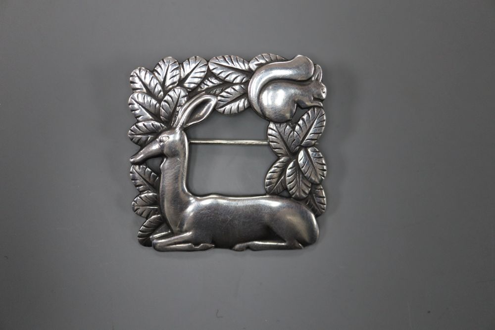 A George Jensen sterling Recumbent deer and squirrel square brooch, design no. 318, 37mm, 16.1 grams.